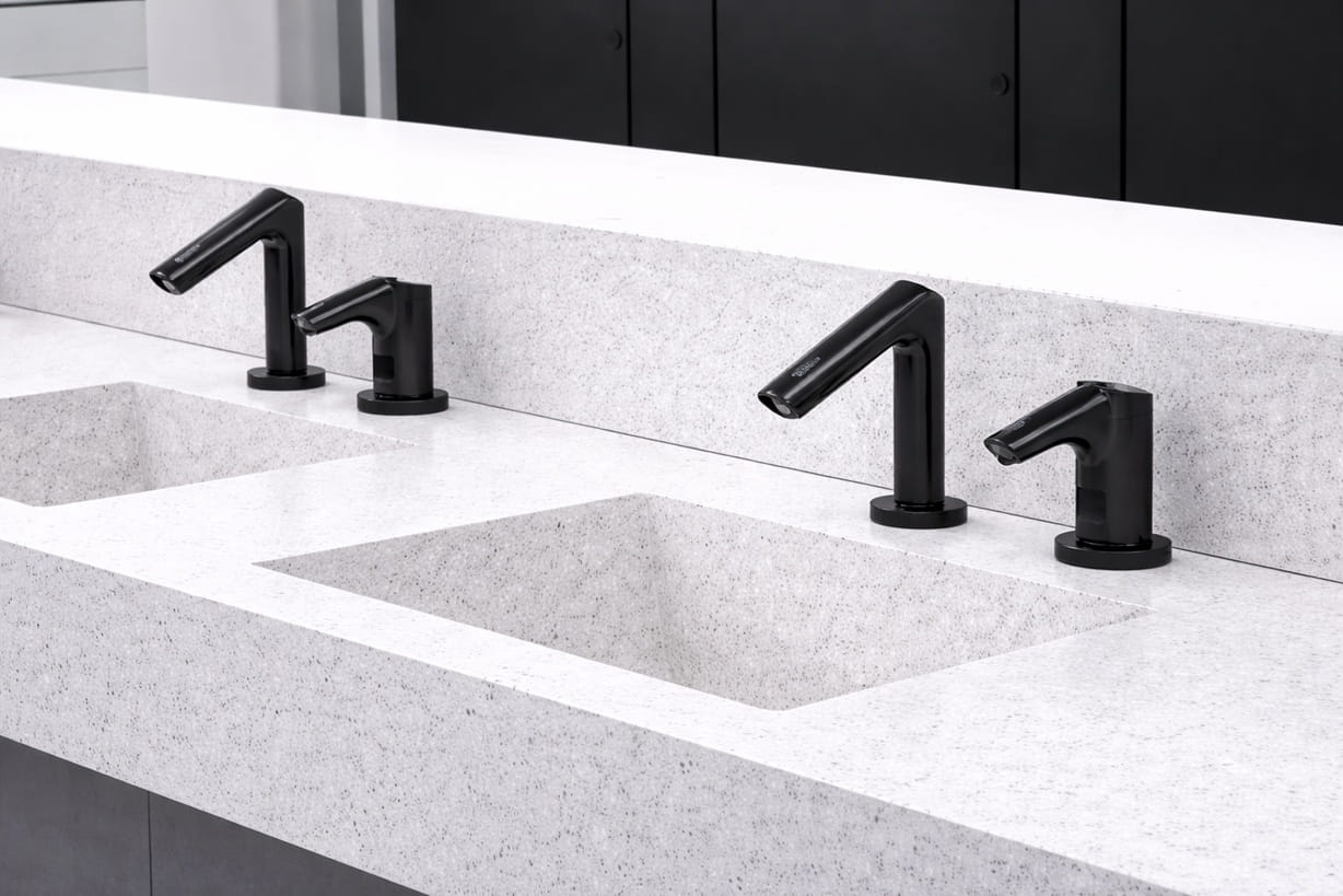 Durable vandal-resistant touchless faucet hardware in a civic facility restroom